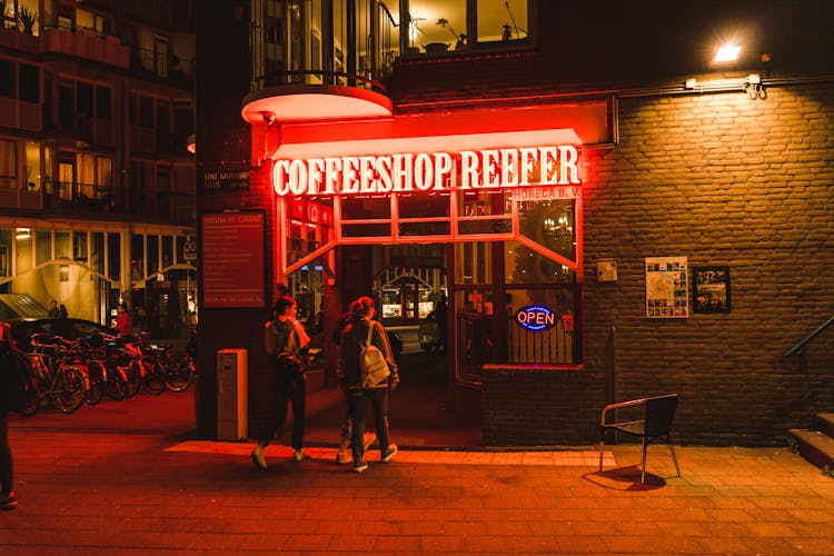 People Entering A Coffee Shop At Night Time