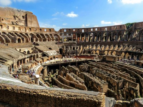 Free Capture of the iconic Colosseum's interior with its ancient architecture under a bright sky. Stock Photo