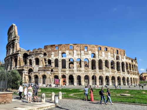 Free Tourists Visiting the Colosseum in Rome Stock Photo