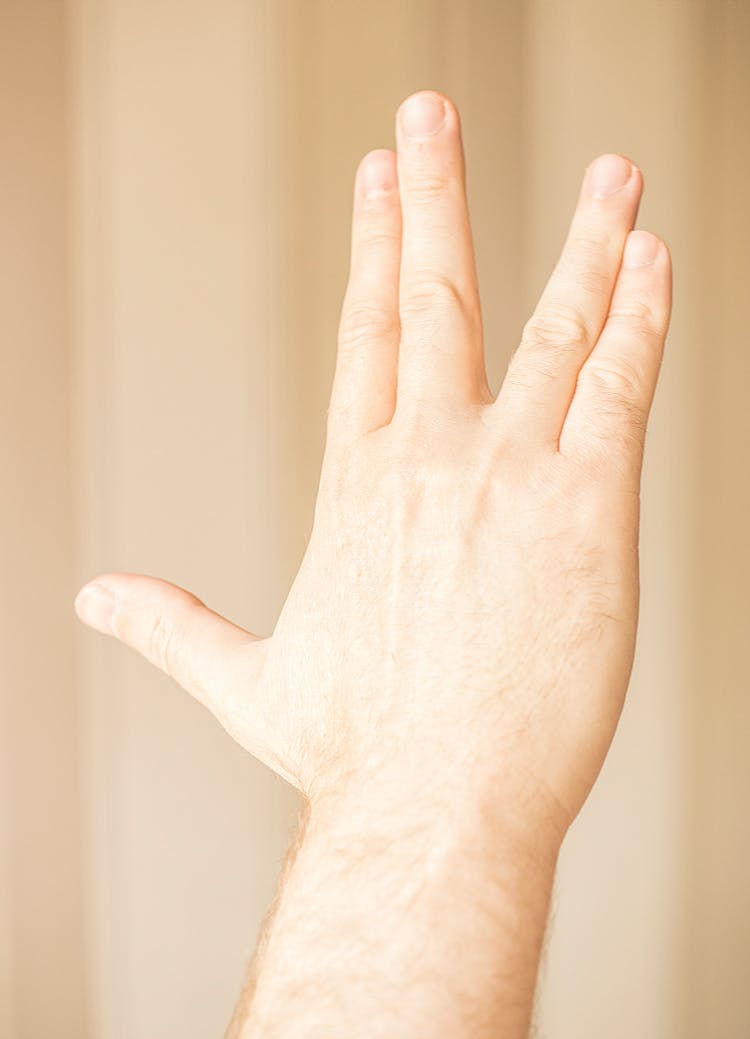 Close-Up Photo Of A Divide Hand Gesture