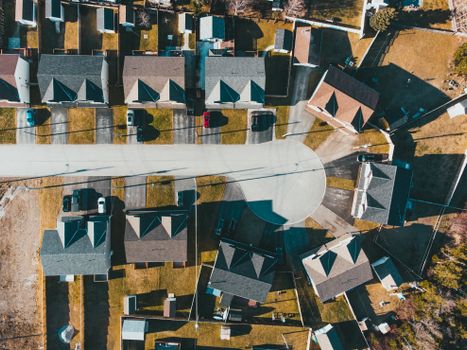Drone view of residential district with modern houses and yard on sunny day in summer