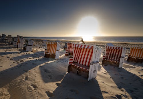 Free Basket Chairs on Shore with View of Sunrise on Background Stock Photo