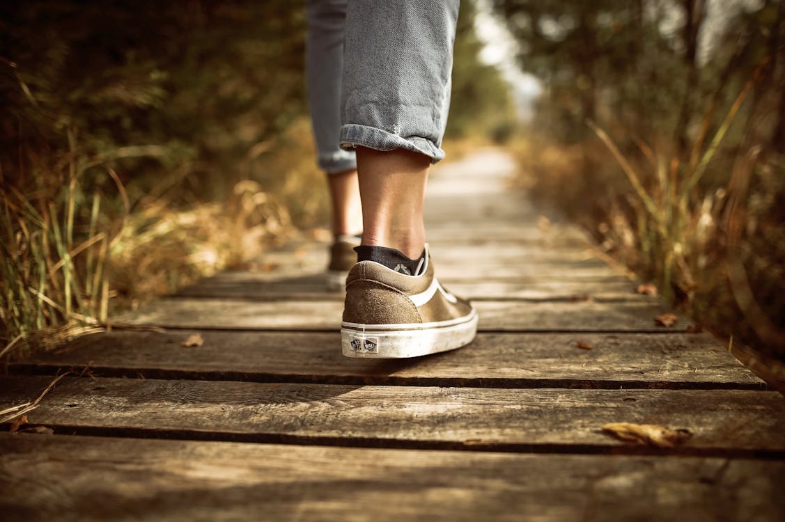 Free Person Stands on Brown Pathway Stock Photo