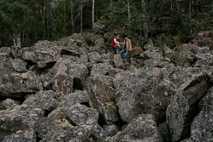 A Couple Hiking On A Rocky Mountain