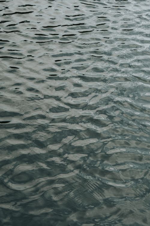 Free A vertical shot of water with gentle ripples creating a calming and textured surface. Stock Photo