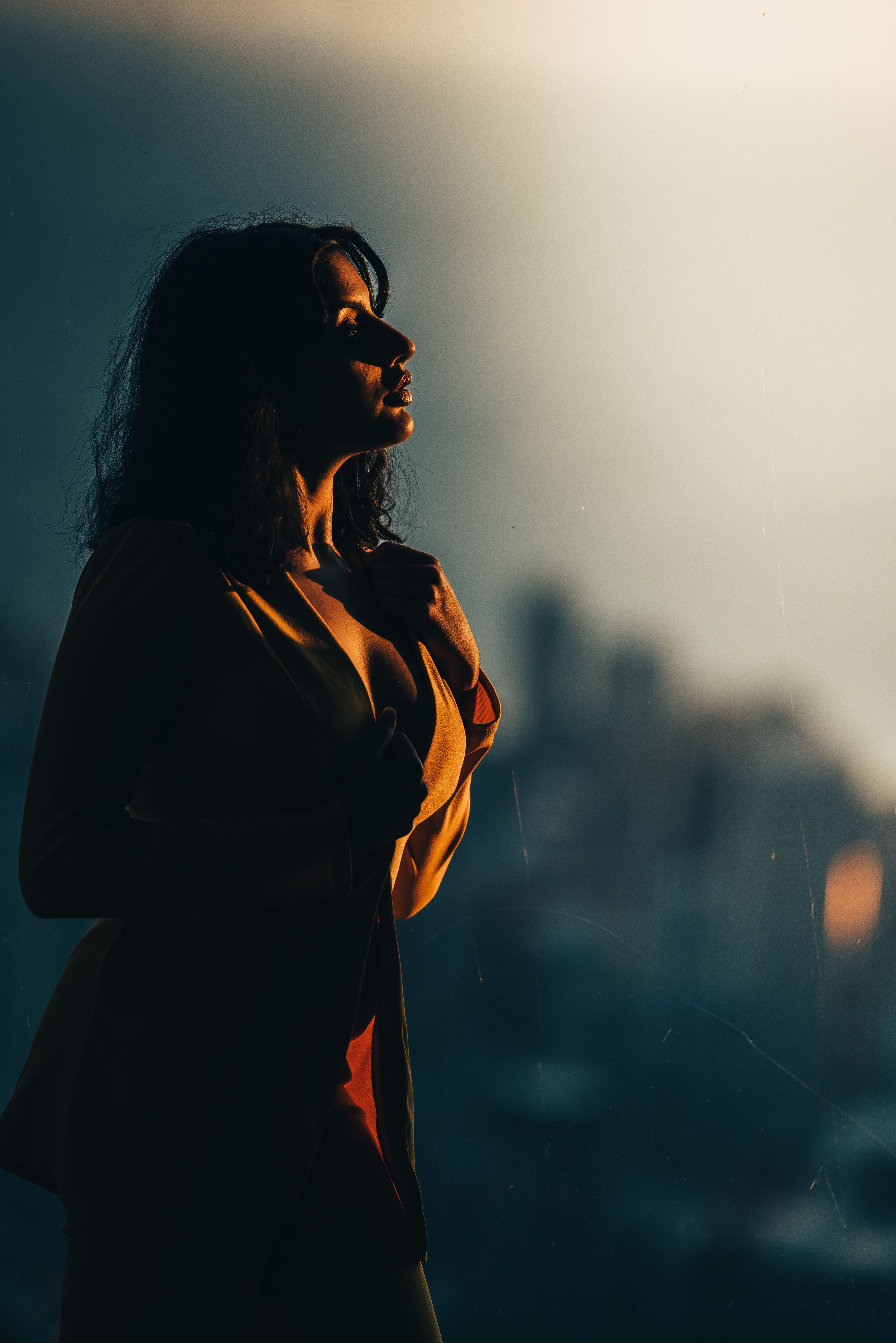 woman silhouette at sunset wearing summer fragrance outdoors lifestyle