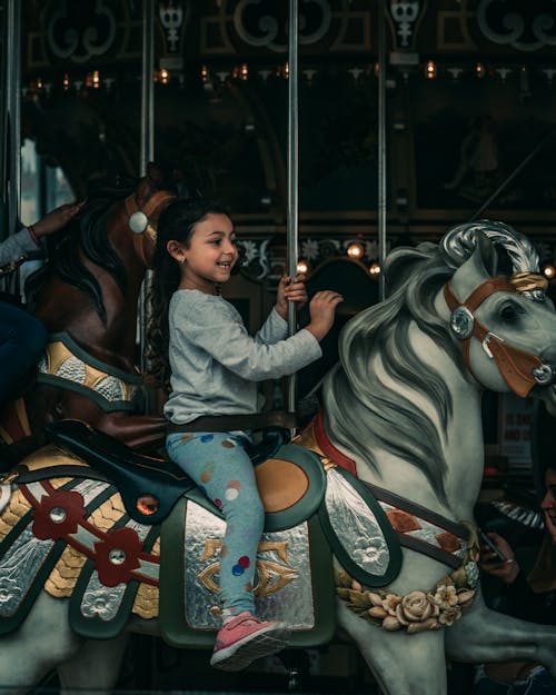 Happy Girl Riding a Merry-go-Round