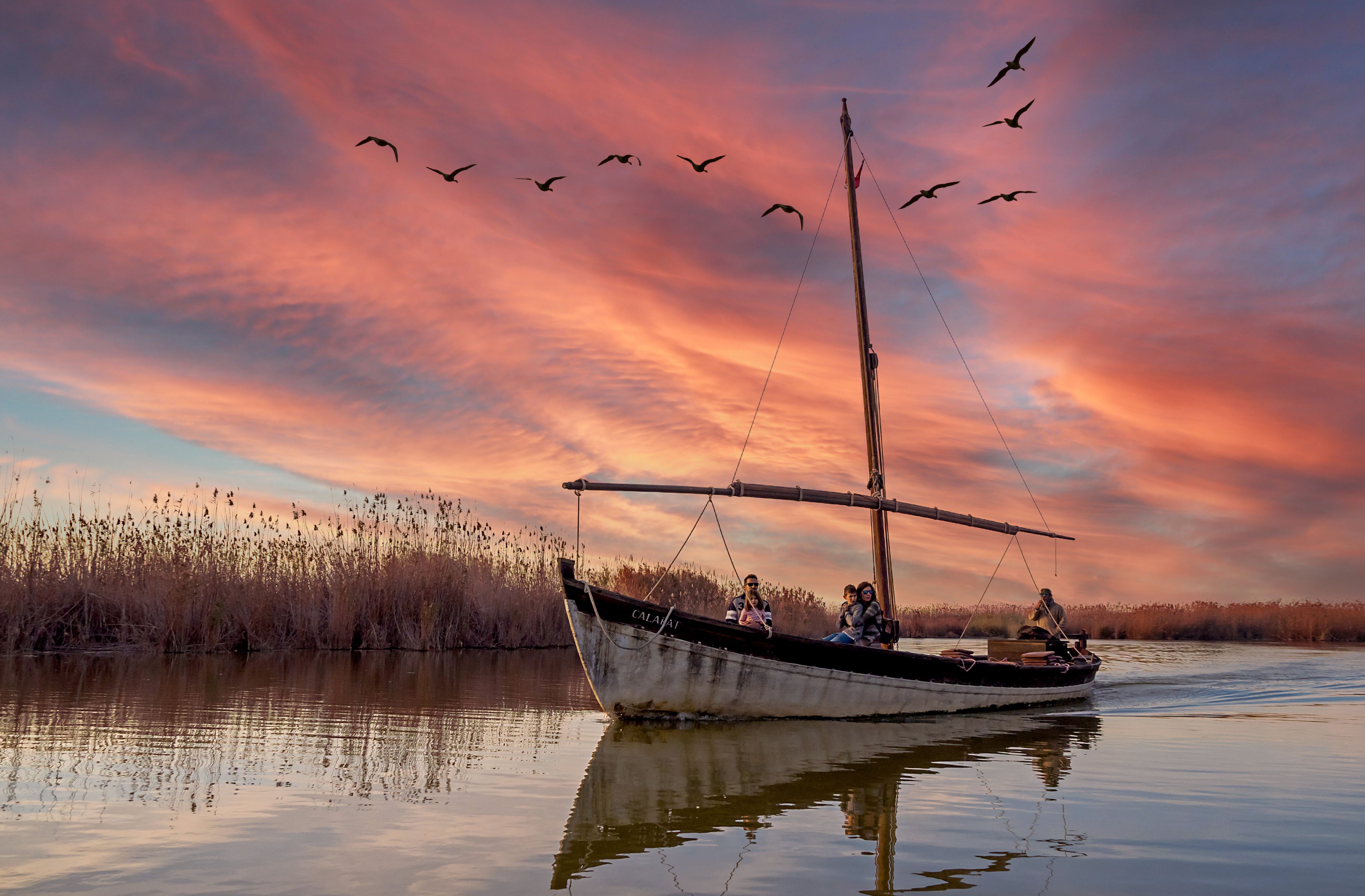 People Riding Boat on Body of Water during Sunset · Free Stock Photo