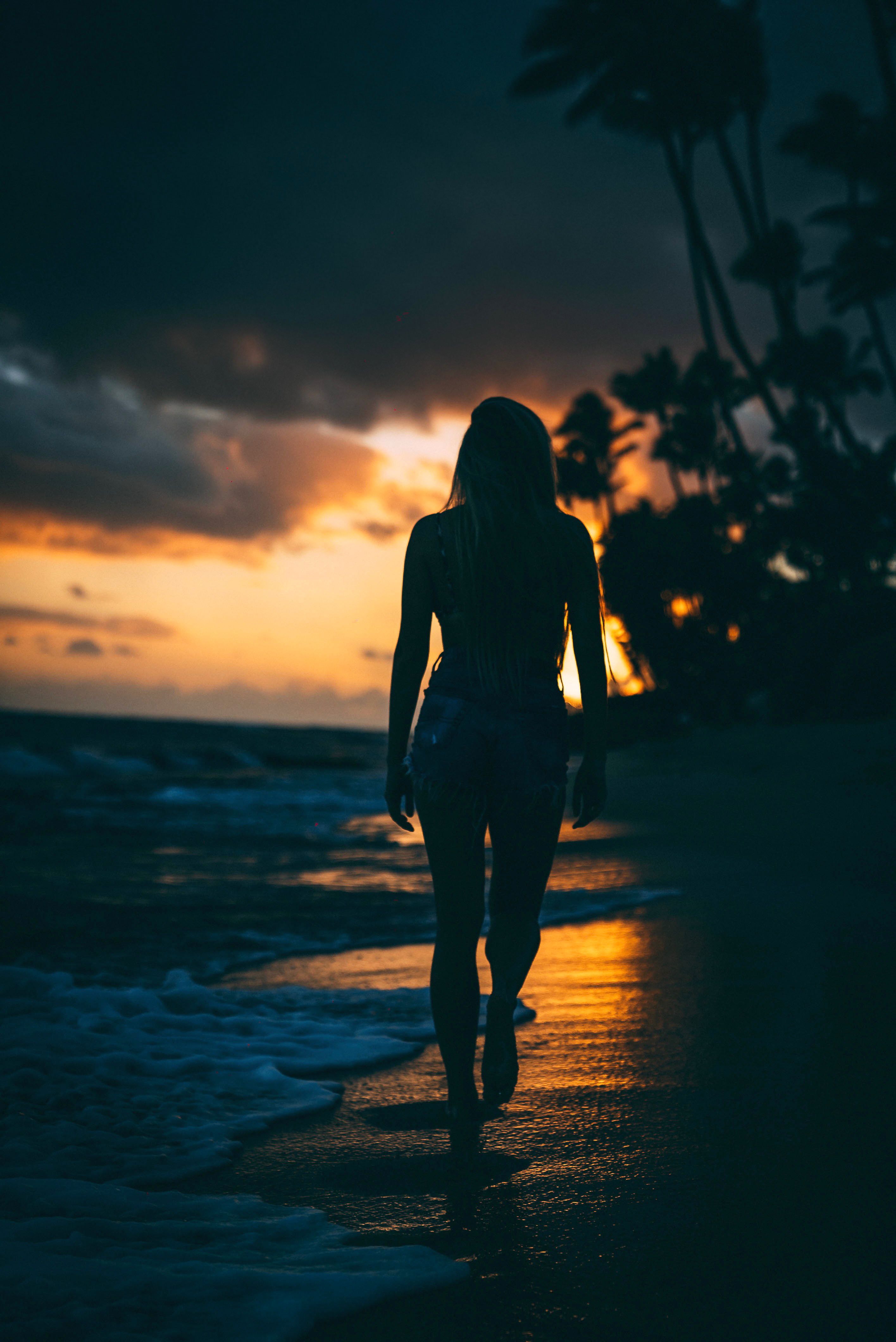 Silhouette of Woman Walking on Beach · Free Stock Photo