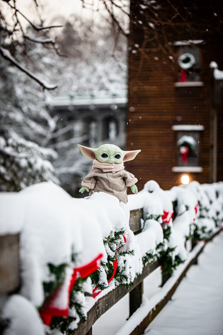 A Toy Yoda Out In The Snow