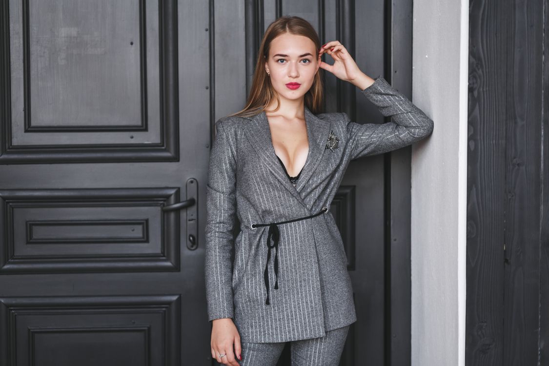 Woman in charcoal trousers with a vest in professional style