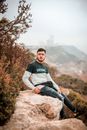 Man Sitting on a Cliff