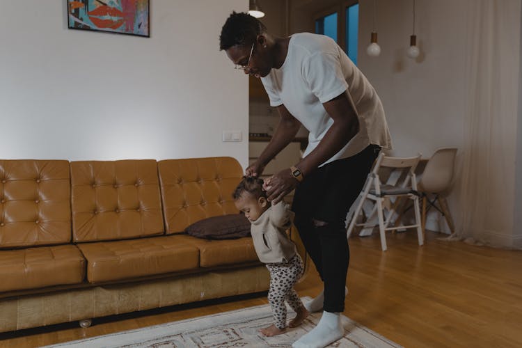  A Father Training Her Daughter To Walk