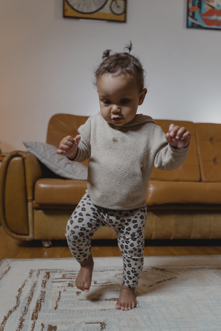 Baby Standing On White Carpet