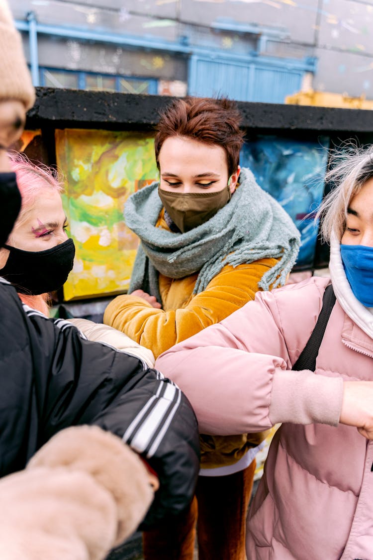 People In Face Masks Greeting With Elbows