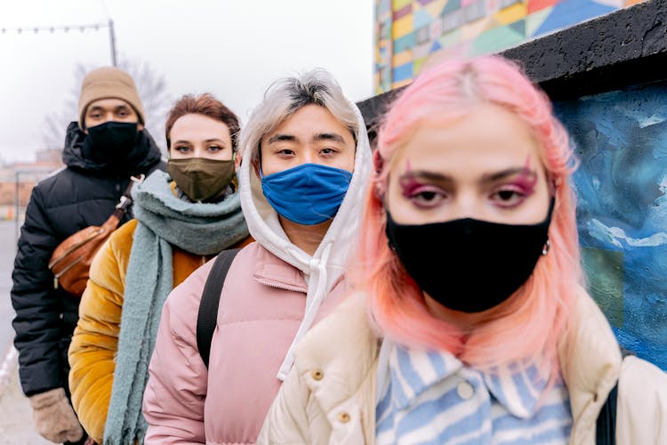 Diverse People In Face Masks In Row Outdoors