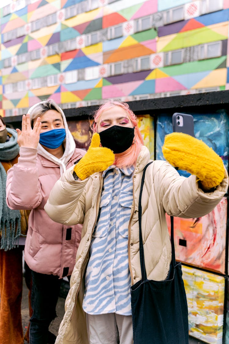 Women With Masks Taking Photo