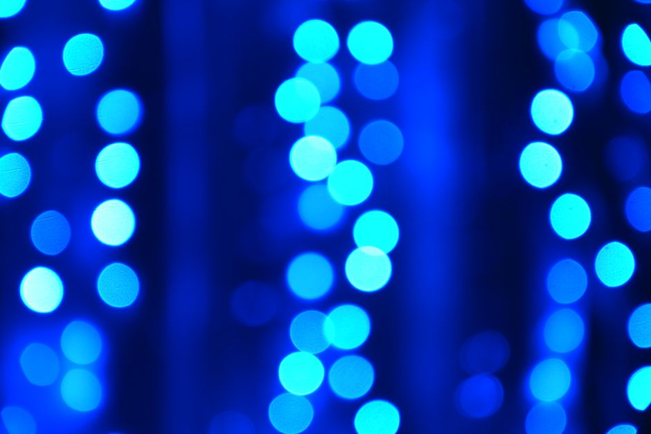 Abstract blue bokeh light patterns — representing the altered states of consciousness and neural activity produced by 5-MeO-DMT acting on serotonin 1A receptors