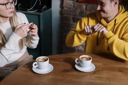 Man and Woman Communicating with Hand Gestures