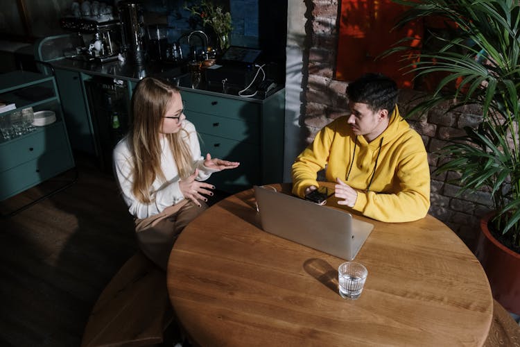 Man And Woman Sitting At Table Having A Conversation