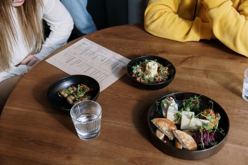 Free Casual meal setting with assorted dishes and beverages on a wooden table, featuring diverse food options. Stock Photo