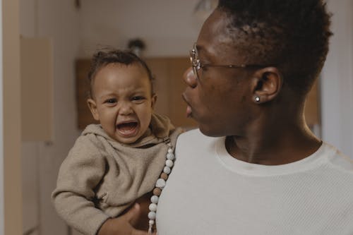 Free Man in White Shirt Carrying a Toddler Stock Photo