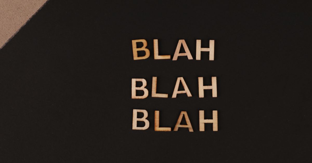Close-up of wooden letters spelling blah , arranged on a black background, offering a conceptual design with copy space