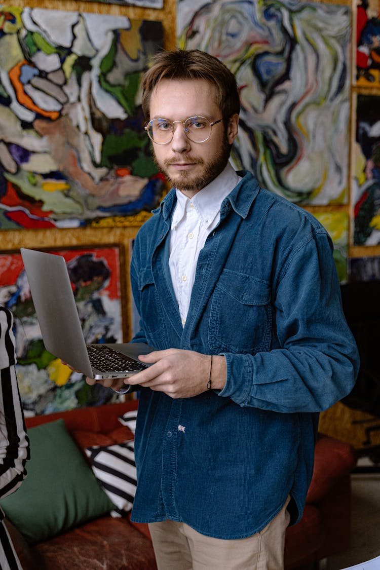 Portrait Of Man With Laptop On Art Background