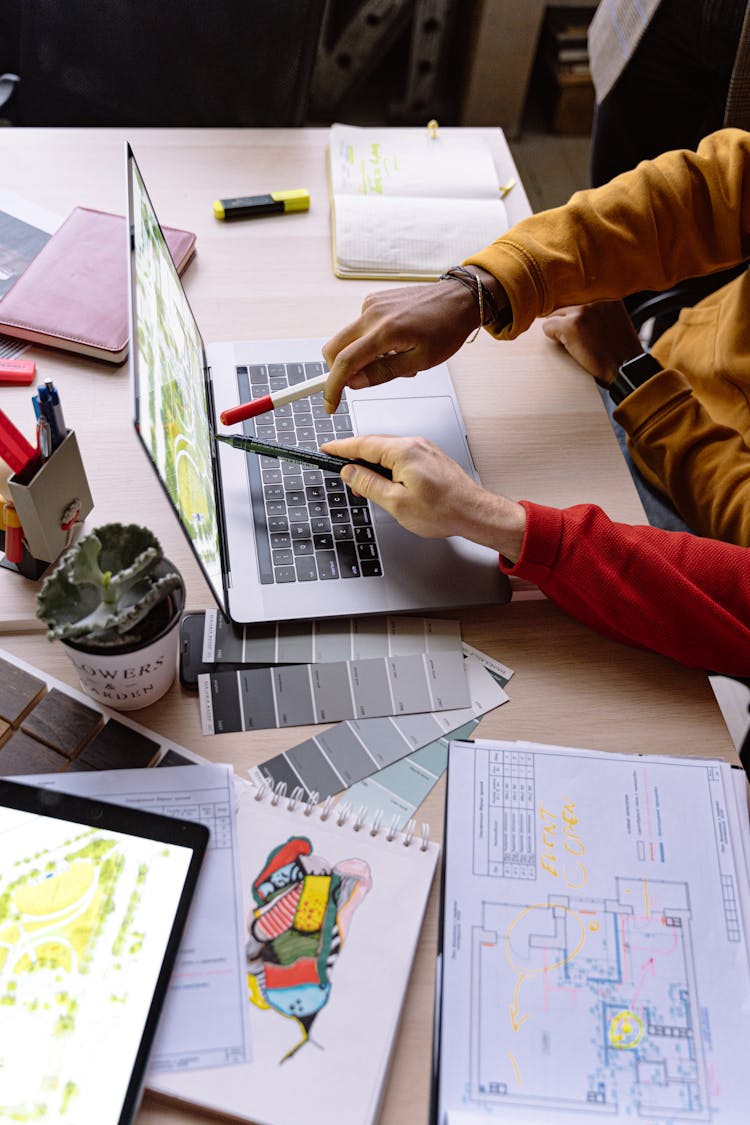 Designers Working On Laptop In Office