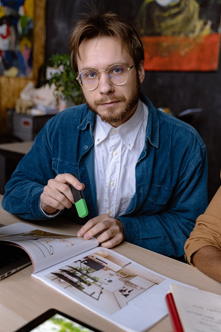 Man Sitting With Catalogue