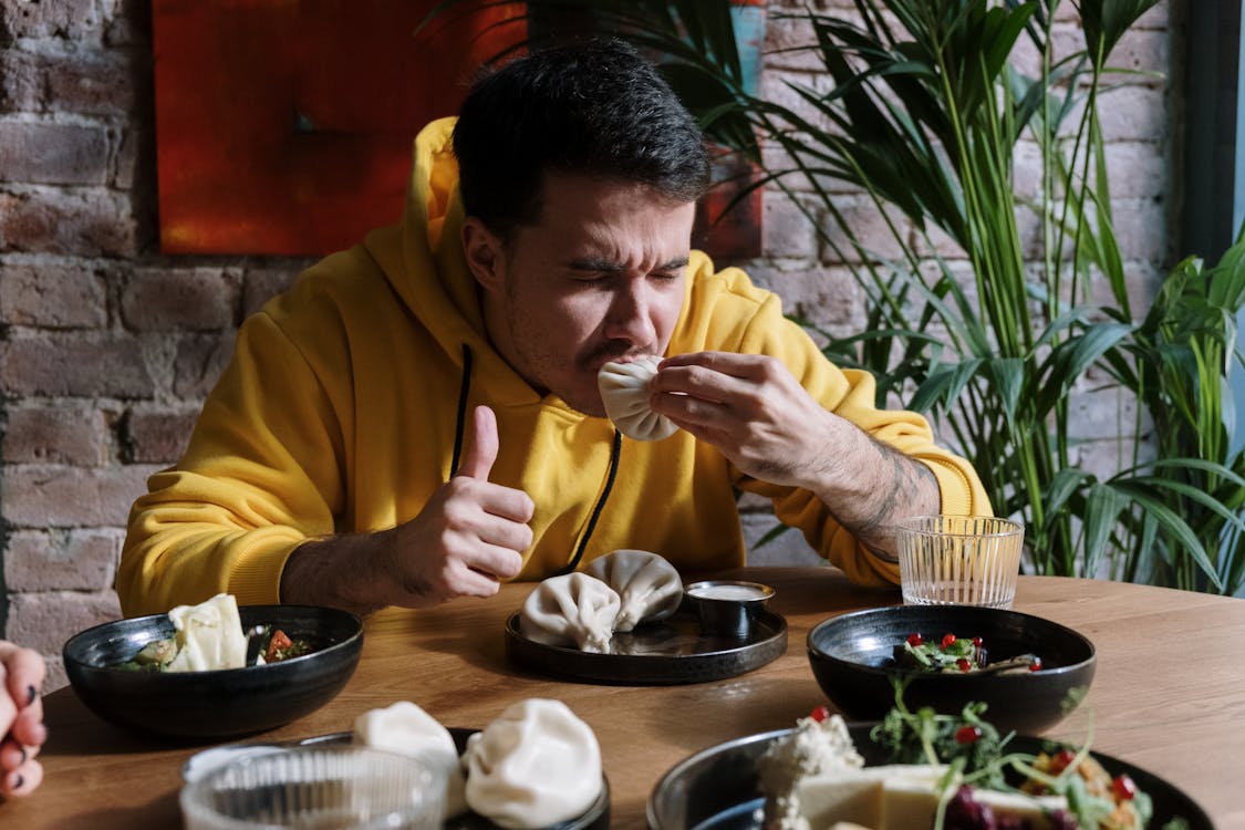 Man Eating Khinkali · Free Stock Photo