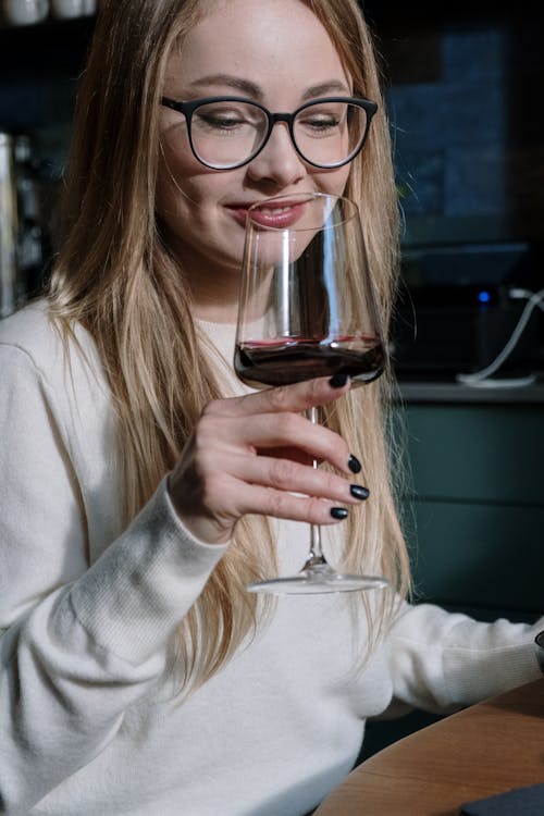 Smiling Blonde Woman Drinking Wine