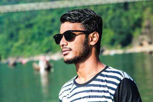 Free A young man with sunglasses by the river at Jaflong, Bangladesh. Stock Photo