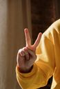 Person in Yellow Long Sleeve Shirt Showing Right Hand