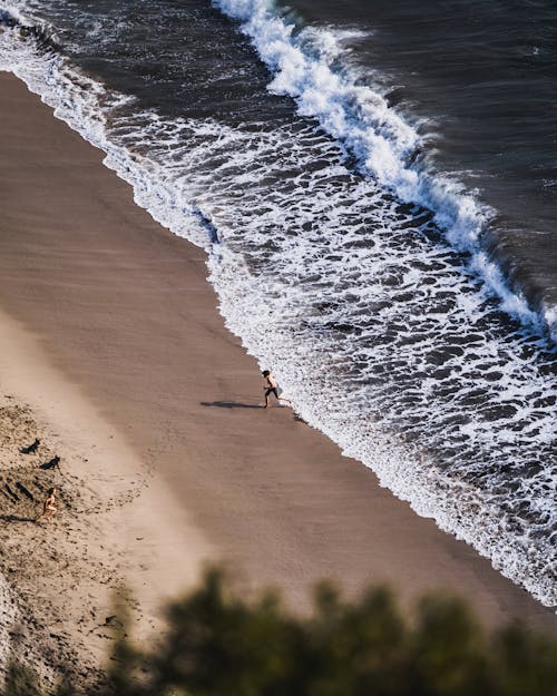 Shirtless Boy Running on Beach