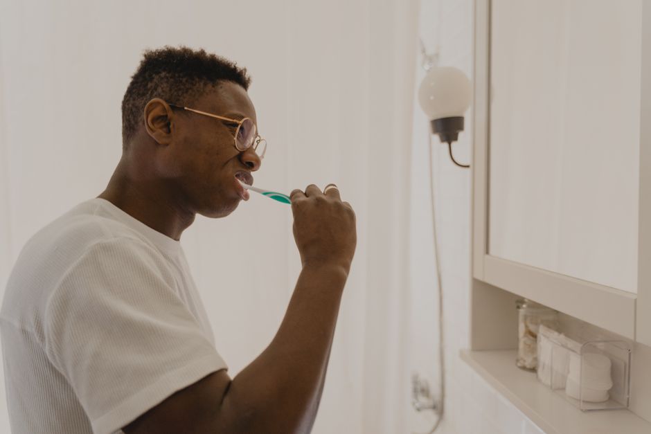 A person brushing their teeth to maintain excellent oral hygiene A person brushing their teeth to maintain excellent oral hygiene