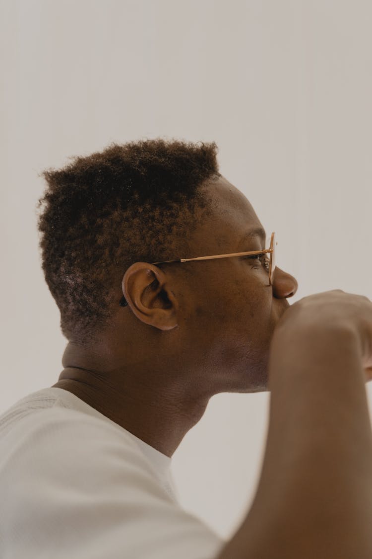 Side View Of A Man Brushing His Teeth