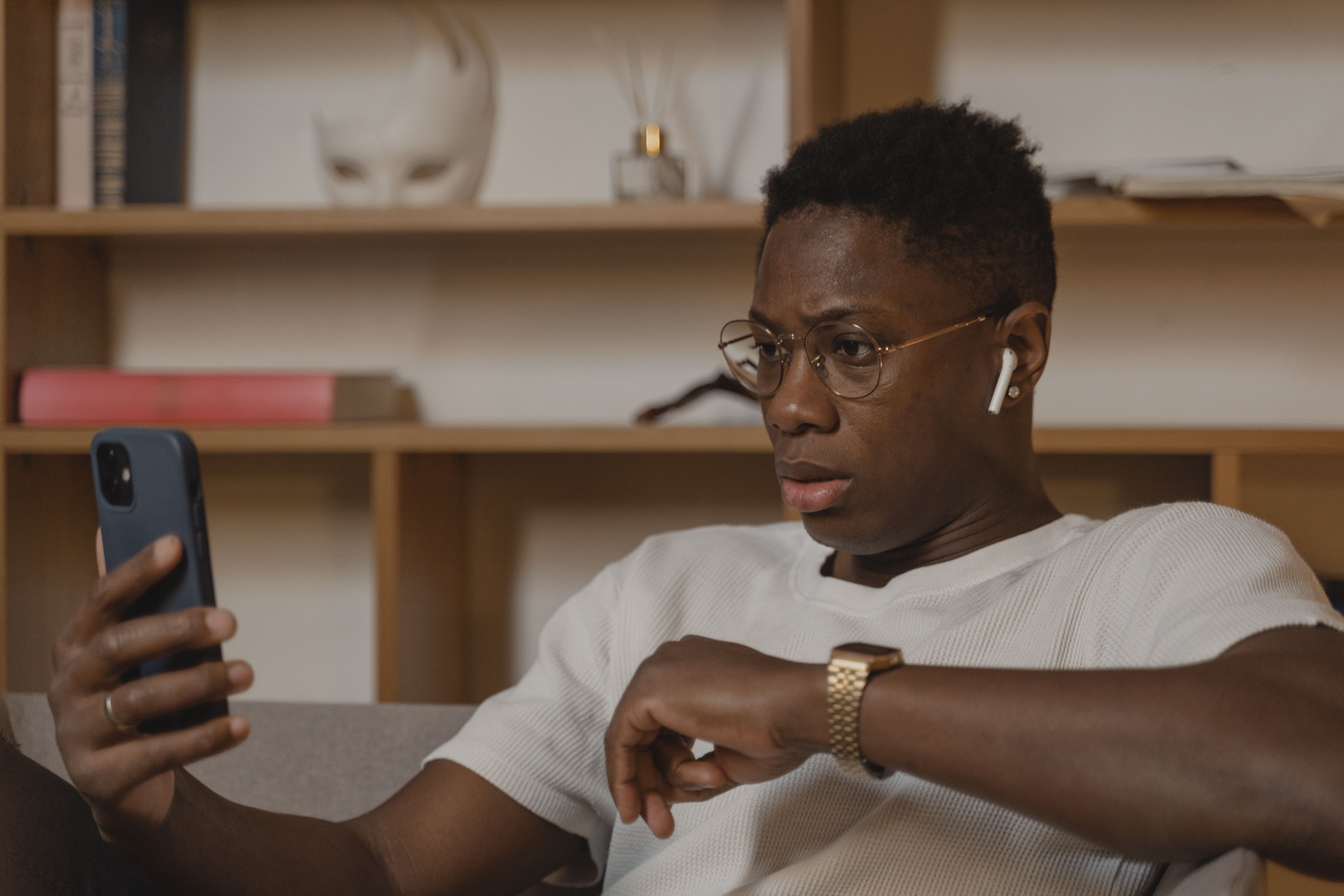 A person wearing AirPods and using a smartphone 