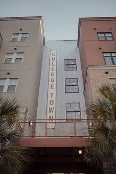 Scenic view of College Town buildings in Florida with palm trees.