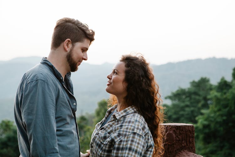 Smiling Young Couple Looking At Each Other In Nature