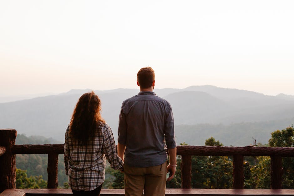 Couple silhouetted against a Kashmir mountain range at sunset