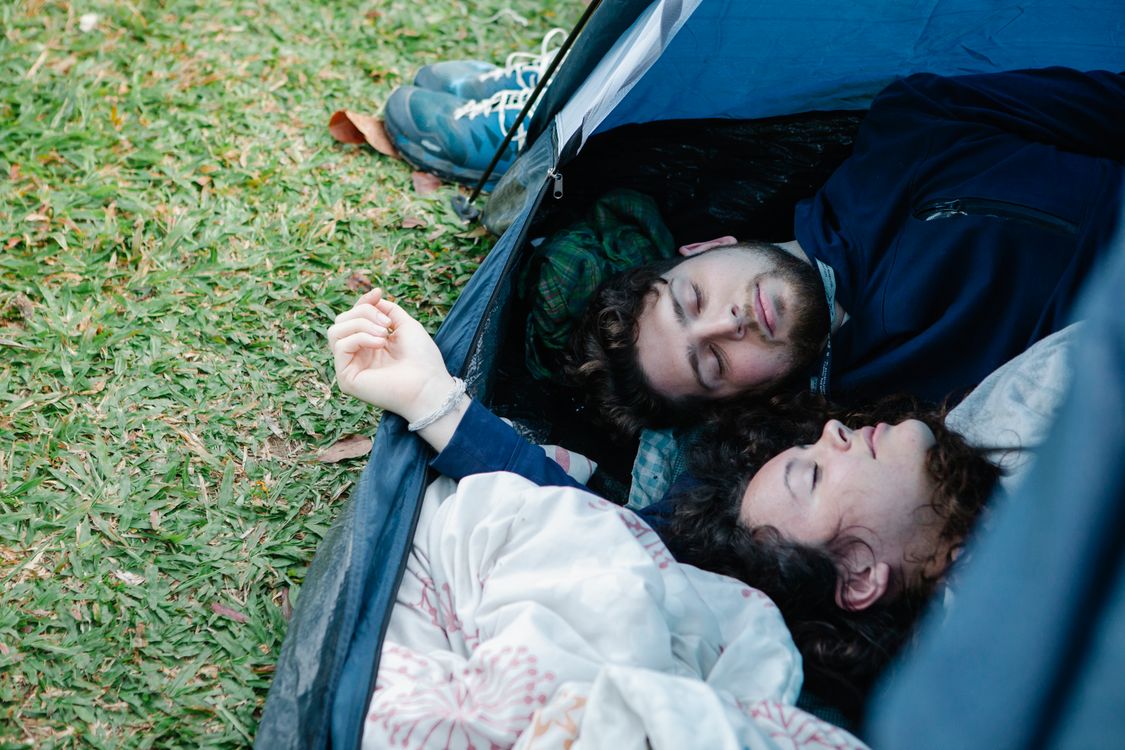 Young couple resting together in tent