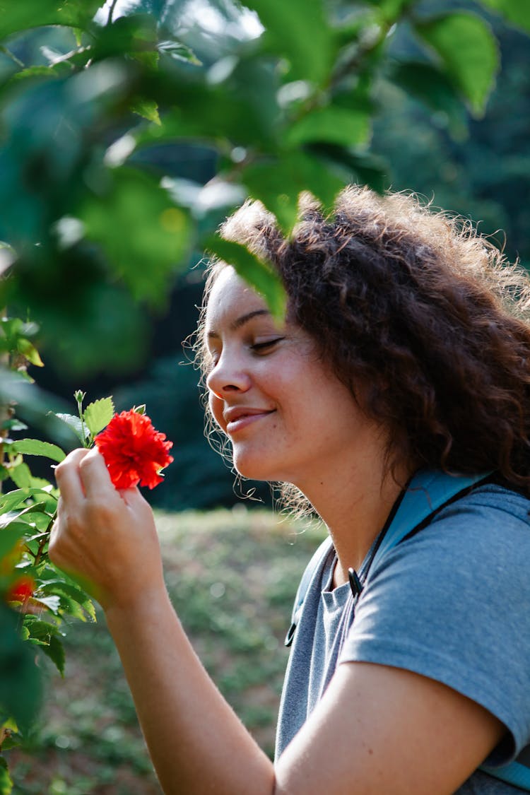 Charming Woman Enjoying Blossoming Hibiscus In Summer Garden