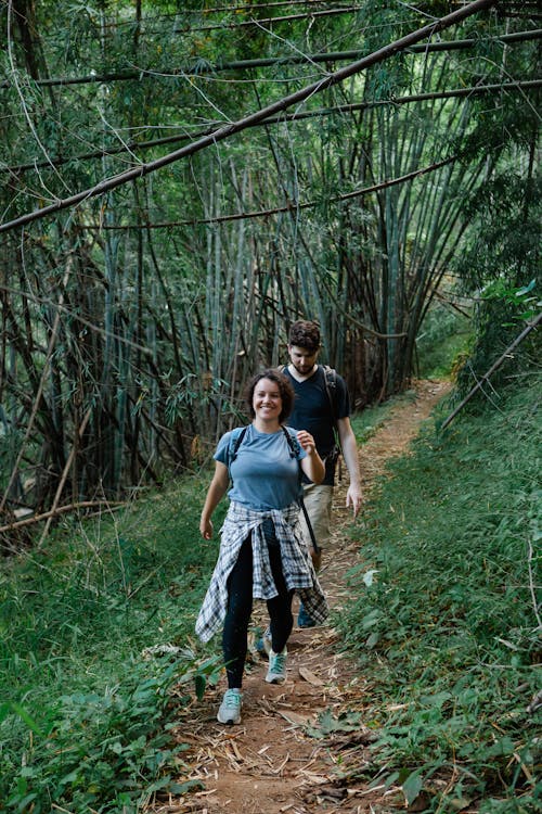 Content young couple hiking in tropical rainforest during summer holidays