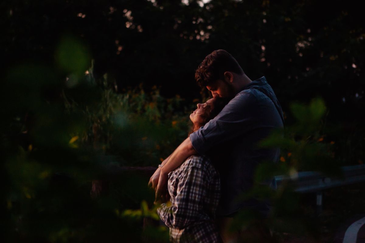 Couple embracing in the forest at sunset