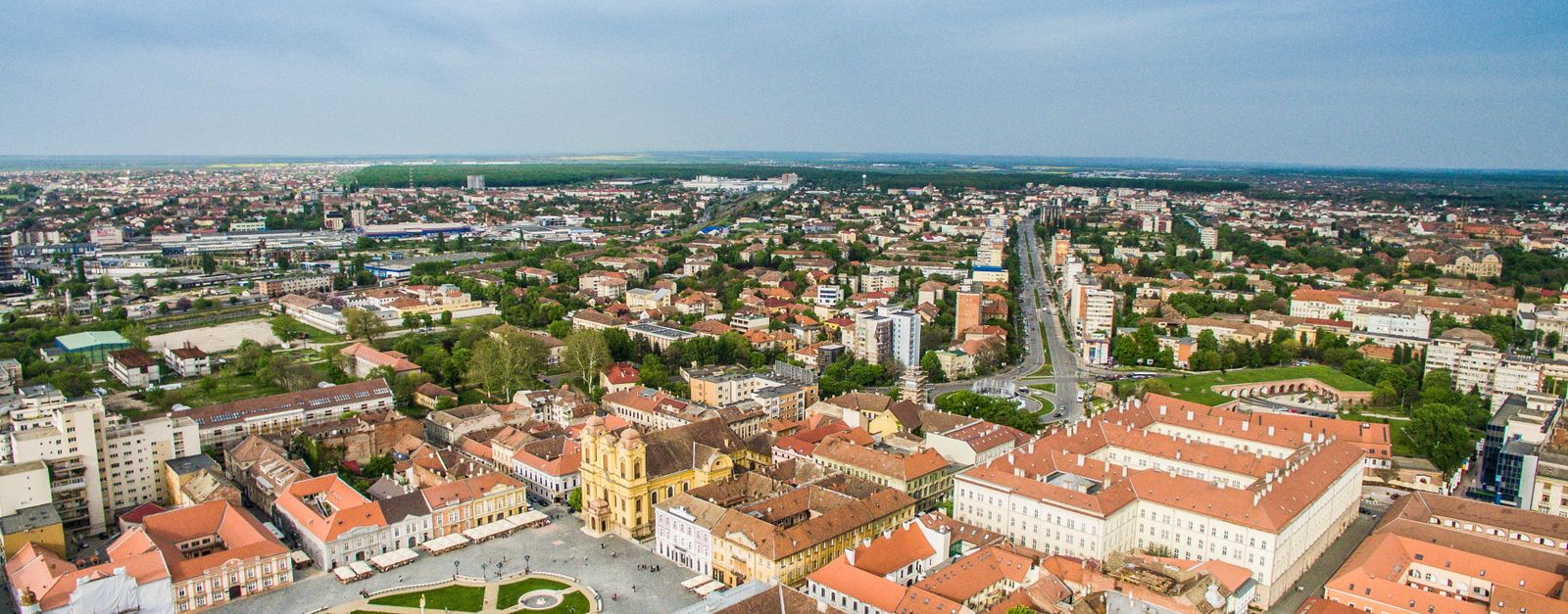 Drone shot of Timișoara's vibrant cityscape showcasing historic architecture and urban layout.