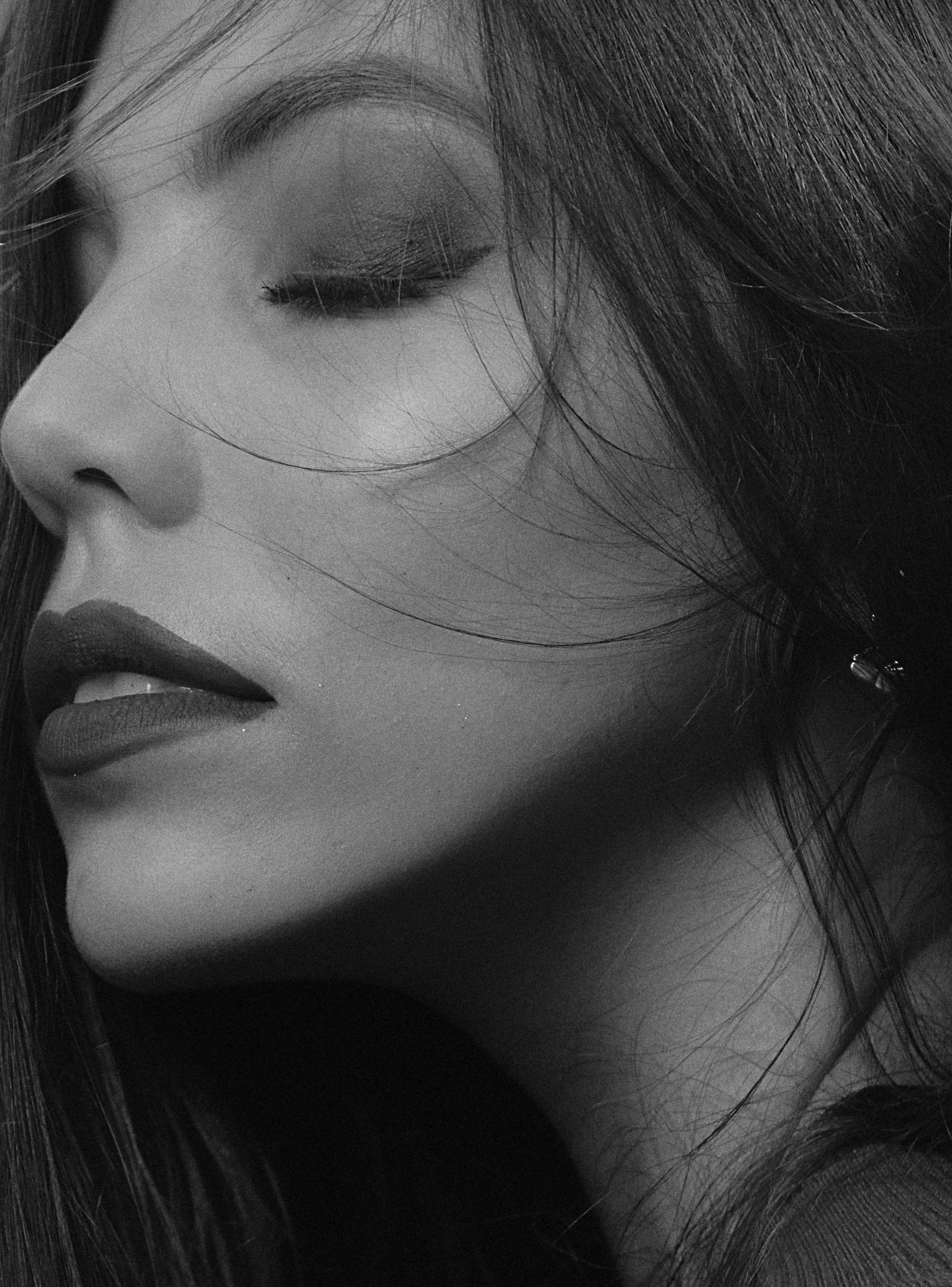 Black-and-white close-up portrait of a woman with closed eyes, Kyiv.