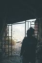 Silhouette of Man Standing in Front of Window