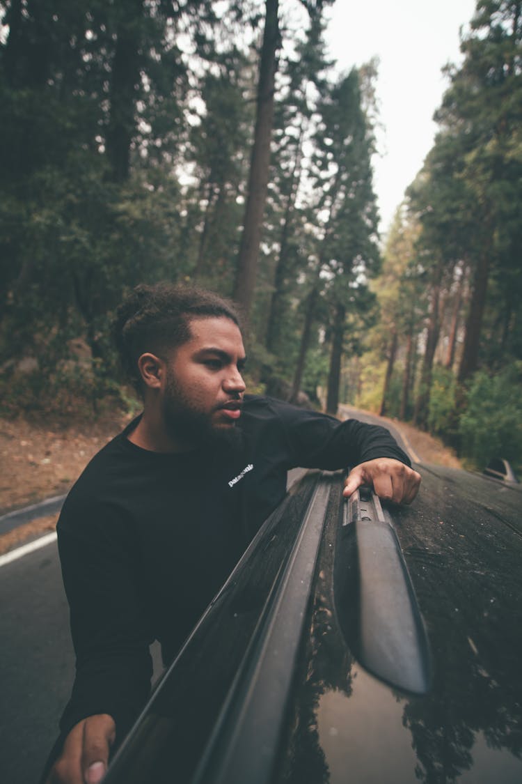 Man Hanging Out Of The Car Window 