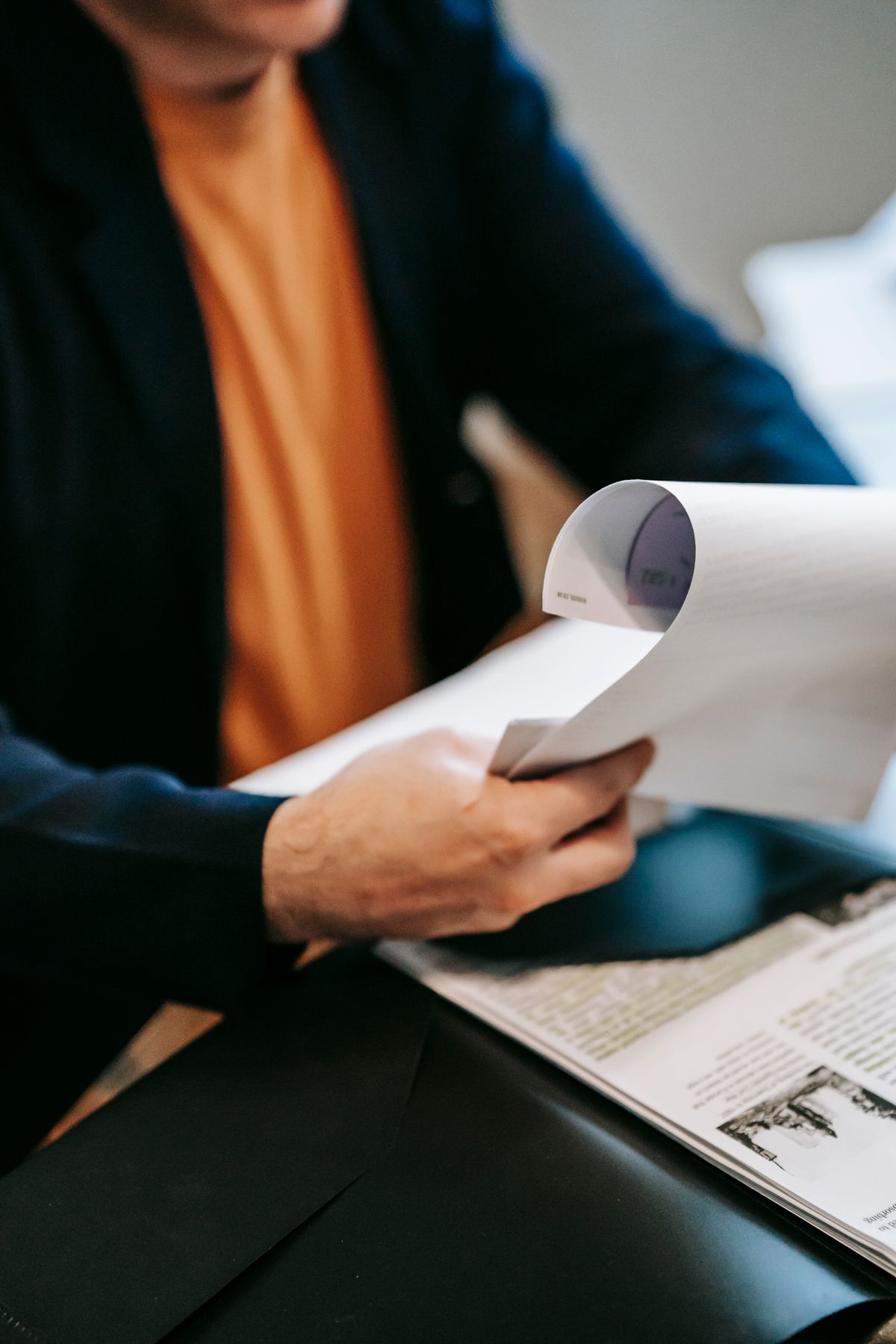Person reviewing a loan agreement and quotation document at a table
